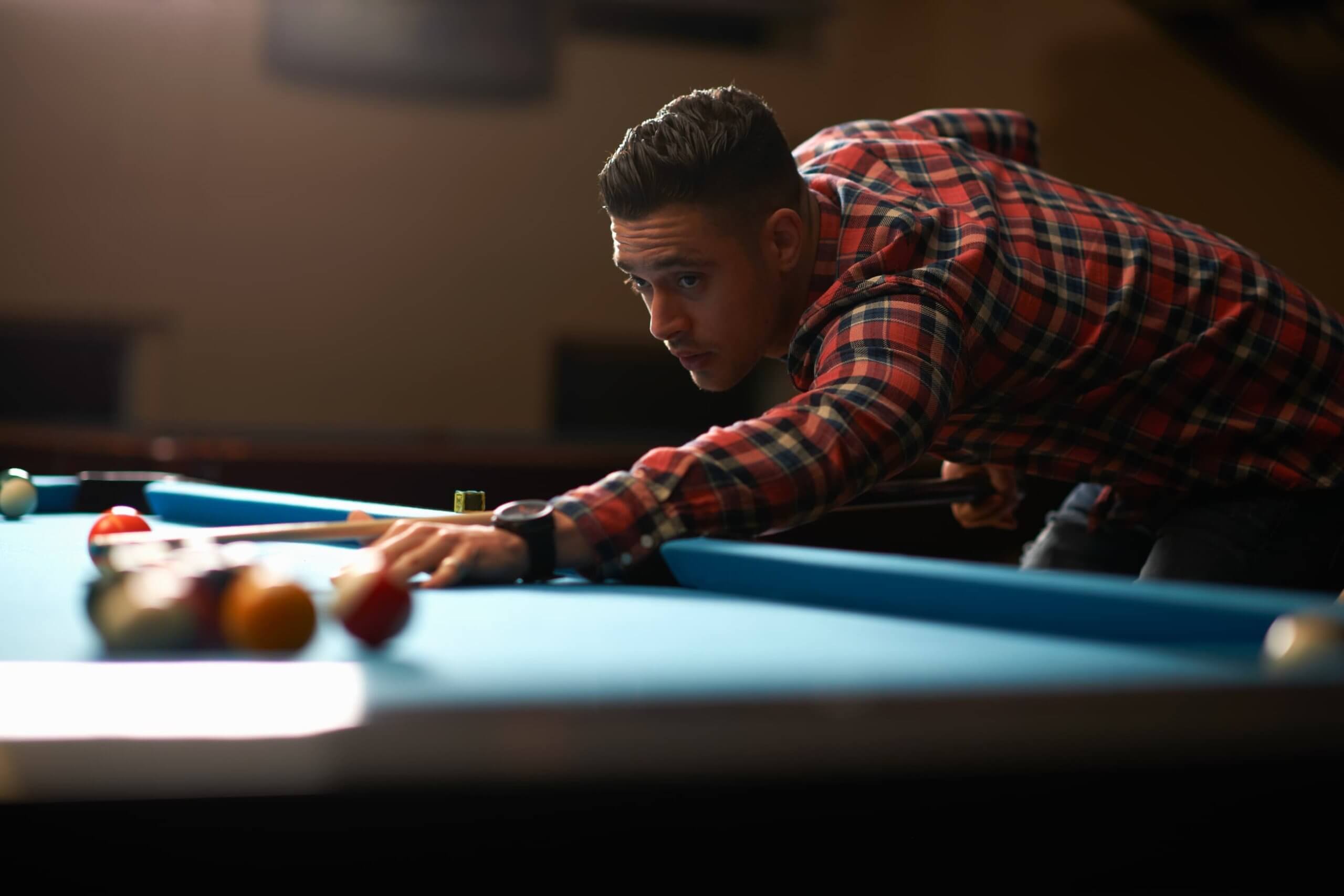 man-playing-pool-in-club